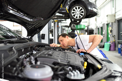 car mechanic in a workshop repairing a vehicle