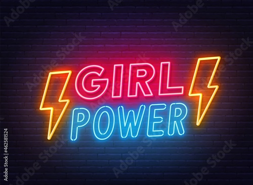 Girl Power neon lettering on brick wall background.