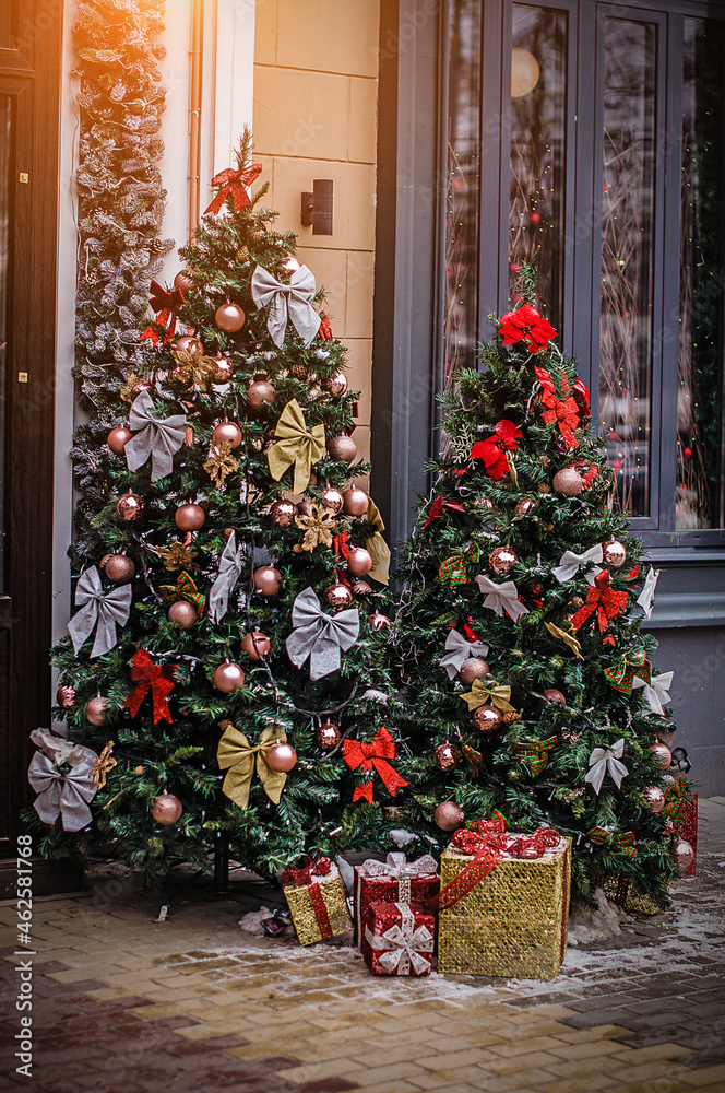 Christmas trees decoretad on the city streets covered with snow