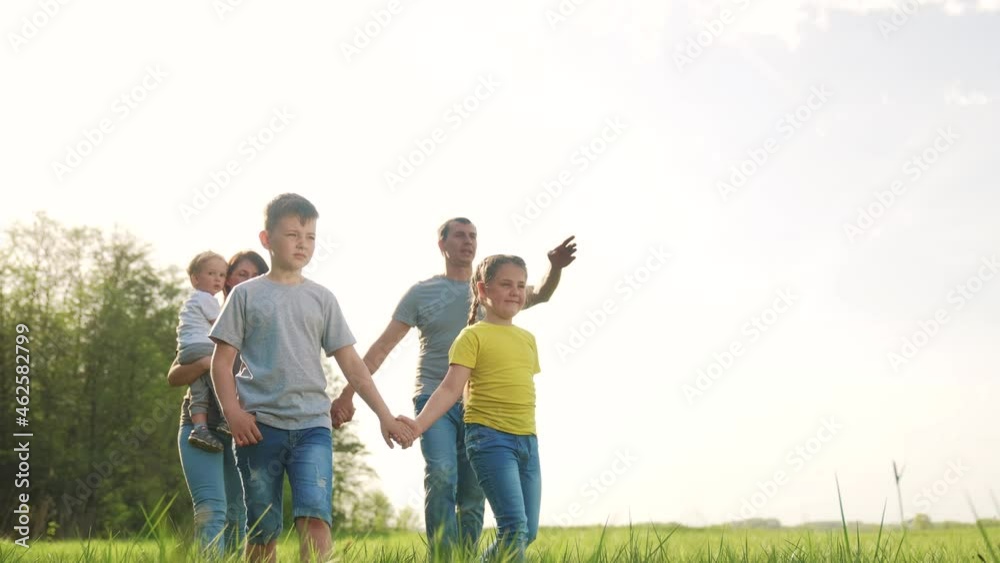 people in the park. happy family kid walk at sunset. mom dad and daughter baby walk holding hands in the park. happy family kid concept. parents and fun children. people dream walk in a green park people in the park. happy family kid walk at sunset. mom dad and daughter baby walk holding hands in the park. happy family kid concept. parents and fun children. people dream walk in a green park