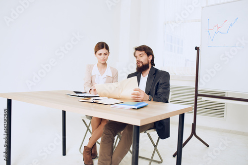 business man and woman sitting at the table working office officials