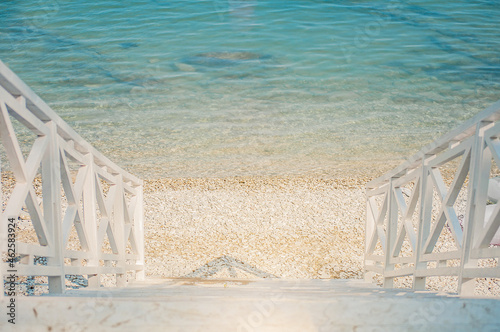 white staircase leading to the sea shore. Vacation background.