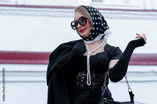 portrait of young woman in headscarf in retro style outdoor