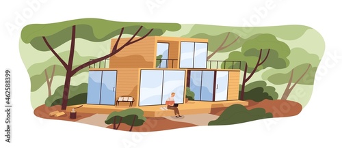 Modern modular house building and person with laptop on wooden patio. Man outside wood and glass home in nature among trees in summer. Colored flat vector illustration isolated on white background