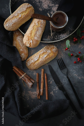 Spain typical pastry: Melindros with hot chocolate. Moody food photography