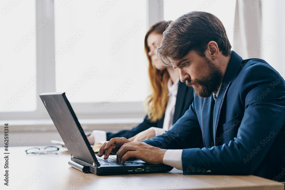 managers sitting at a desk with a laptop communication finance professionals managers sitting at a desk with a laptop communication finance professionals