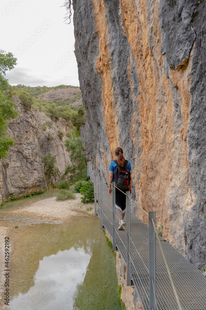 Woman walking down iron footbridge, athlete woman