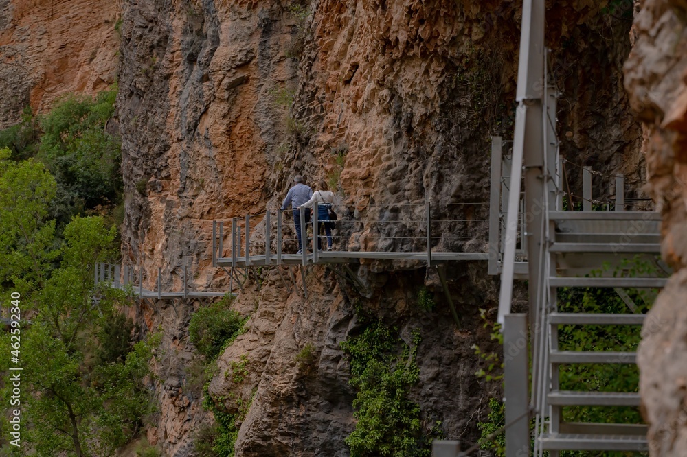 Mr and Mrs walking on iron catwalks.