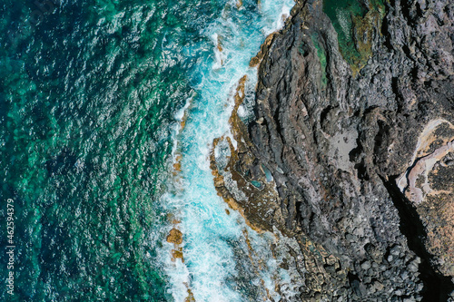 Aerial view of ocean waves, birdseye view of waves and rocks, blue waves and rocks, beautiful deep blue waves, amazing aerial view of coastline with deep blue waves and rocks. Tenerife, Canary Islands