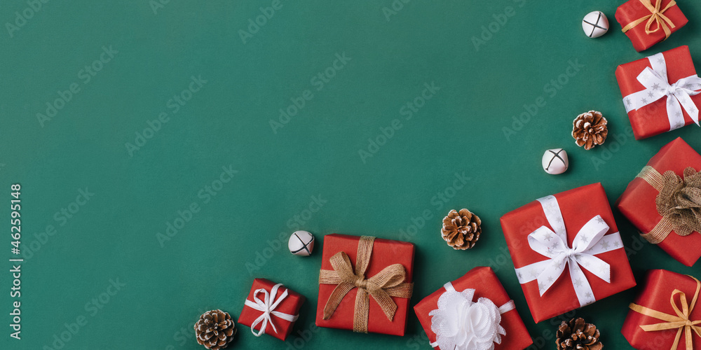 Gift boxes with white and brown bows on a green backdrop.