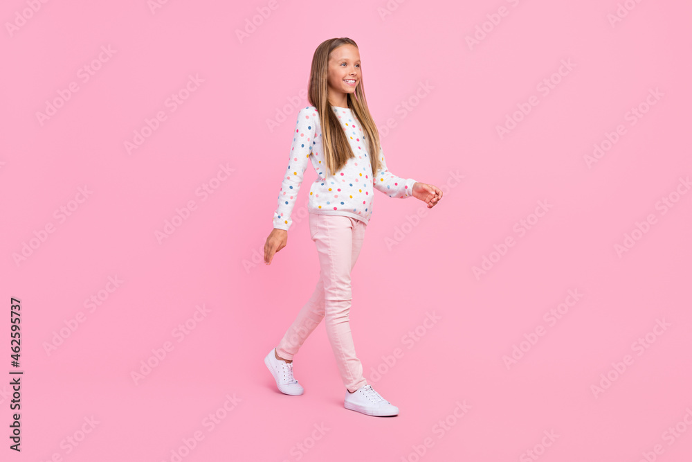 Profile photo of positive nice carefree small lady walk wear dotted shirt pants footwear isolated pink color background Profile photo of positive nice carefree small lady walk wear dotted shirt pants footwear isolated pink color background