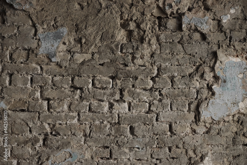 Structure of old stone damaged ancient brick wall and plaster for texture background closeup.