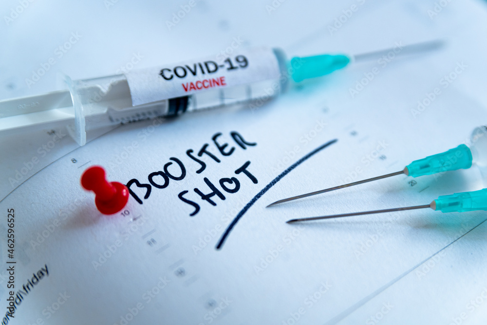 Third covid vaccine dose and jab concept. Three syringes are seen on calendar as a concept for the 3rd covid-19 vaccine dose, also called booster shot, now requested during the vaccination campaign. - obrazy, fototapety, plakaty 