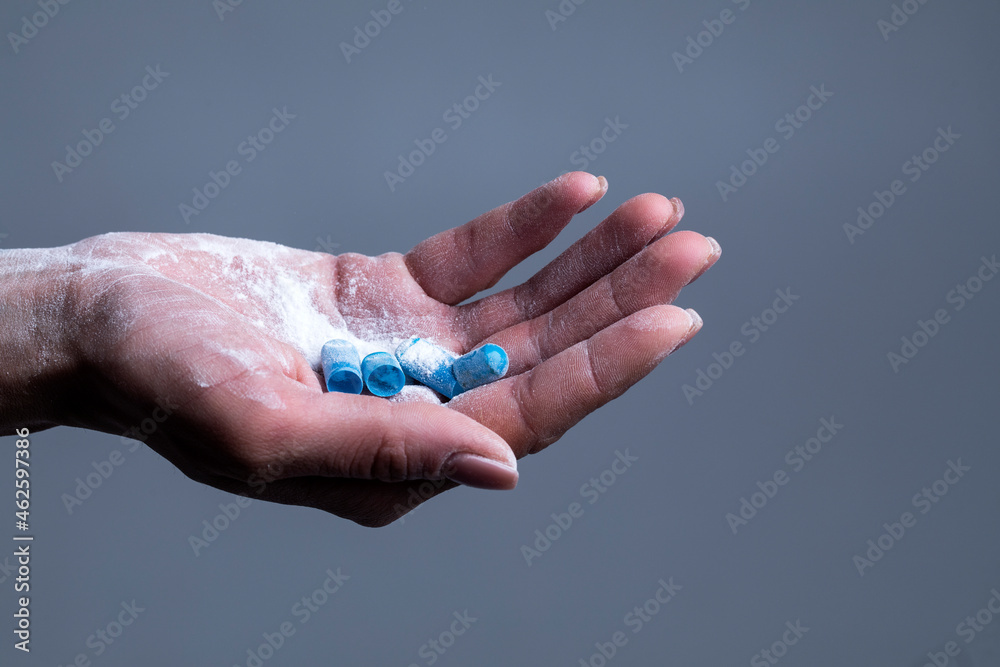 Fototapeta premium Female hand holds capsule. Capsule. Pills. Background. 