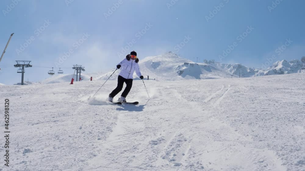 Skier Slides Down Snowy Slope In Mountains In Winter On Ski In Movement Skier Slides Down Snowy Slope In Mountains In Winter On Ski In Movement