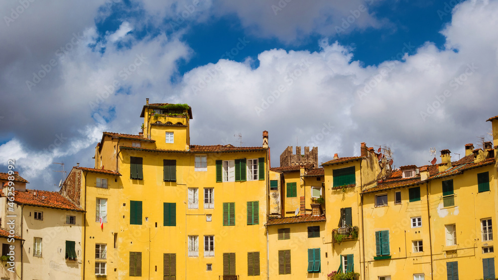 Lucca Amphitheater characteristic medieval houses with clouds
