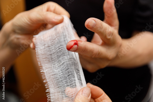 Φωτογραφία Applying a bandage to the wound of a man's finger