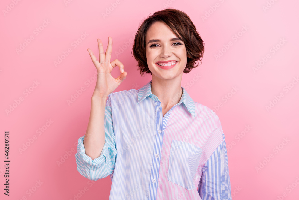 Photo of young woman happy positive smile show okey sign deal done decision promo isolated over pink color background Photo of young woman happy positive smile show okey sign deal done decision promo isolated over pink color background