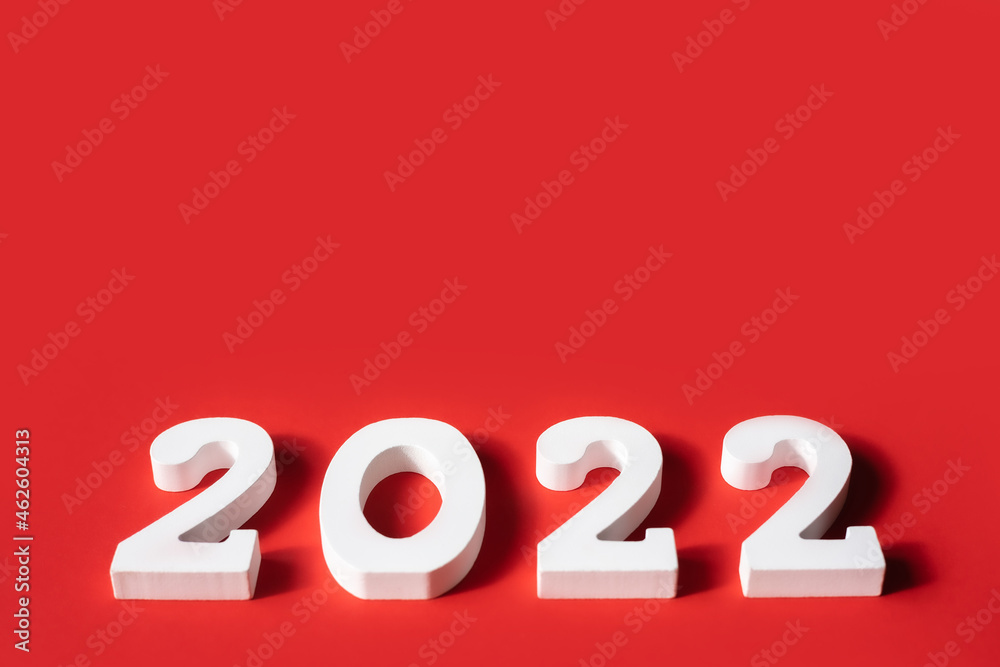 Happy New Year. White wooden numbers 2022 isolated on red background . Greeting card. Copy space. Top view, flat lay. Happy New Year. White wooden numbers 2022 isolated on red background . Greeting card. Copy space. Top view, flat lay.