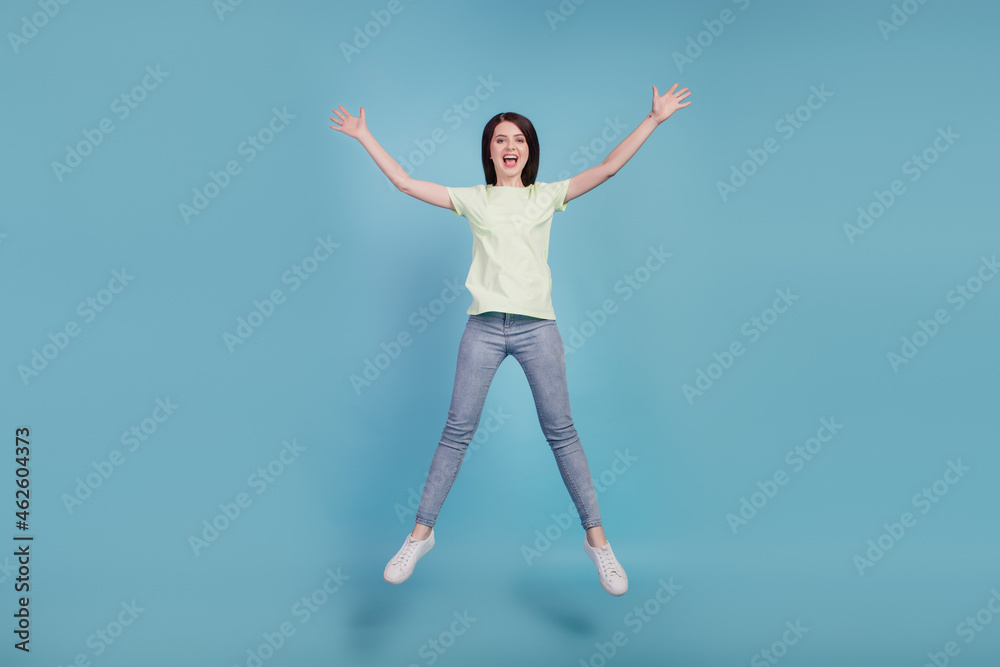 Full body photo of young cheerful girl have fun jump up sale amazed surprised isolated on turquoise color background