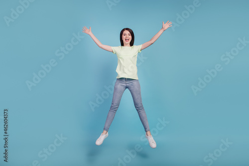Full body photo of young cheerful girl have fun jump up sale amazed surprised isolated on turquoise color background