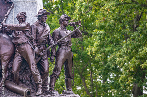 Statue of Civil War soldiers in front of trees during the fall 