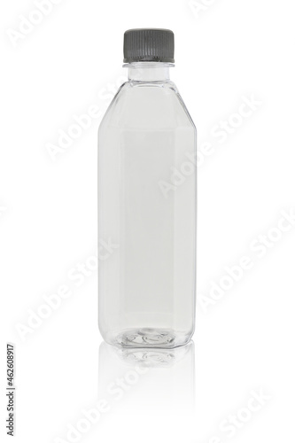 An empty bottle made of transparent colorless plastic, closed with a lid. Isolated on a white background, with reflection.