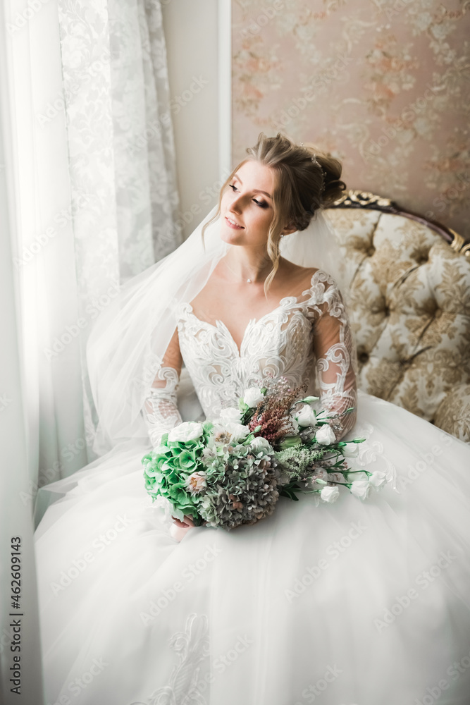 Beautiful bride wearing fashion wedding dress with feathers with luxury delight make-up and hairstyle, studio indoor photo shoot Beautiful bride wearing fashion wedding dress with feathers with luxury delight make-up and hairstyle, studio indoor photo shoot