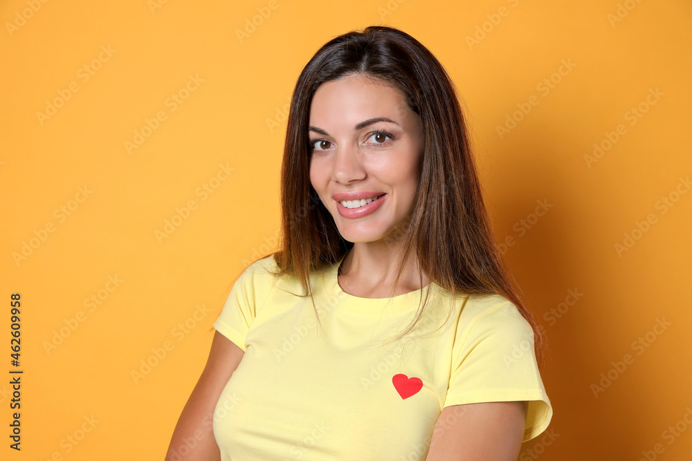 Obraz premium Portrait of beautiful woman on yellow background