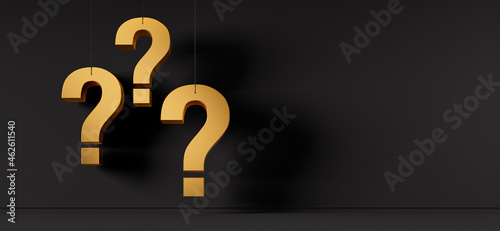 Three golden question marks in front of a black wall 