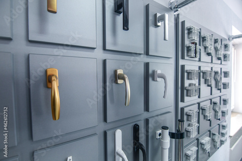 Plastic window handles and different type profiles exhibited in show room. Selective focus