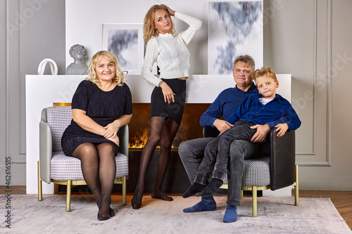 Portrait of caucasian family during evening in living room.