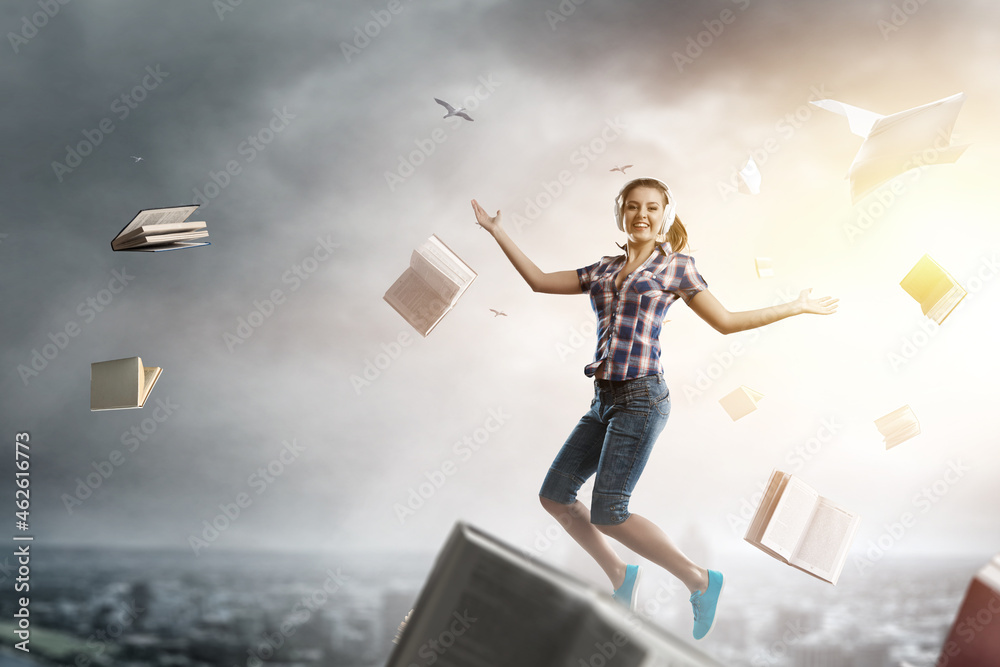 Woman wearing headphones jumping . Mixed media Woman wearing headphones jumping . Mixed media