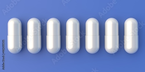 White pills capsules tablets in row isolated on blue background. 3d illustration