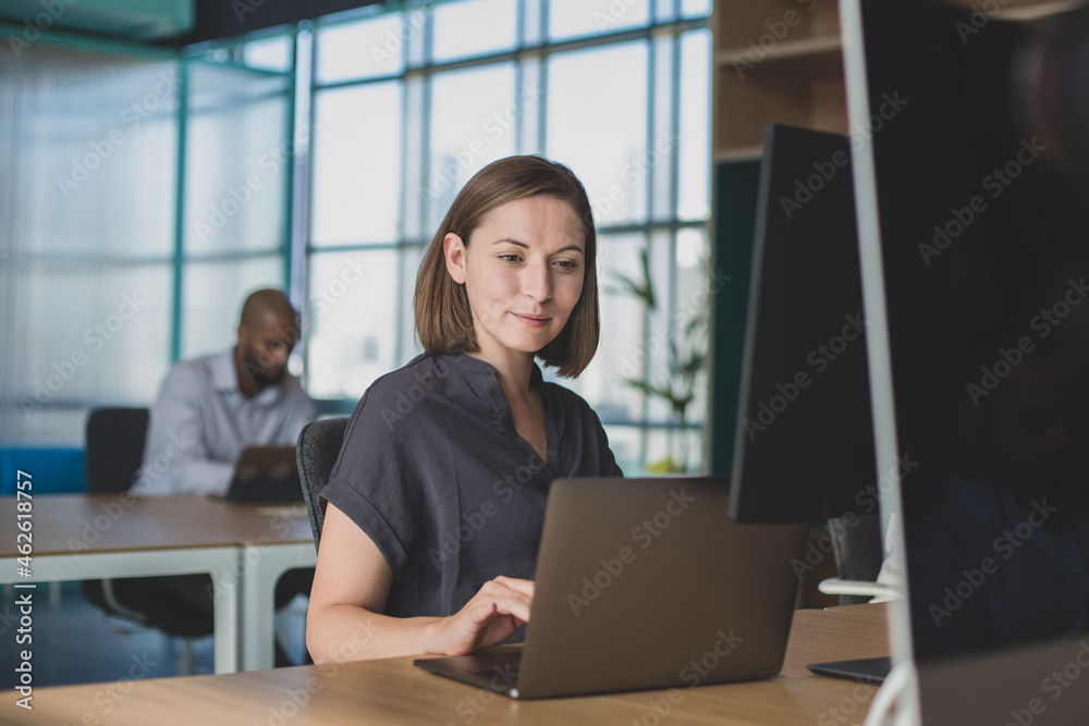 Businesswoman working in a coworking office space Businesswoman working in a coworking office space