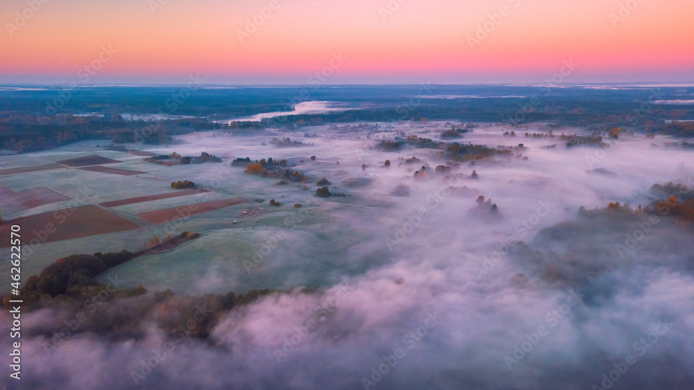 Aerial view of morning fog over the fields at Autumn