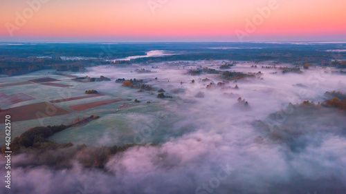 Aerial view of morning fog over the fields at Autumn