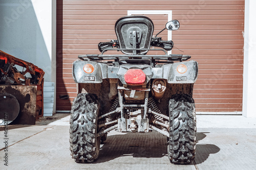 Photo of ATV near the garage