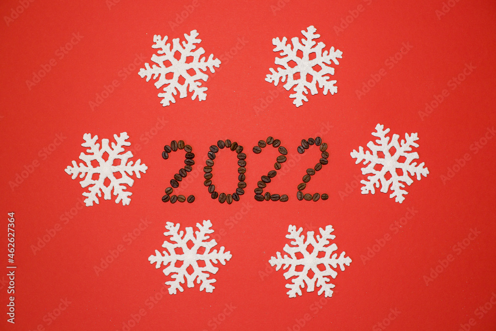 The numbers 2022 on a red background with white snowflakes. Figures 2022 from coffee beans. Coffee beans. New Year 2022. White snowflakes on a red background. The numbers 2022 on a red background with white snowflakes. Figures 2022 from coffee beans. Coffee beans. New Year 2022. White snowflakes on a red background.