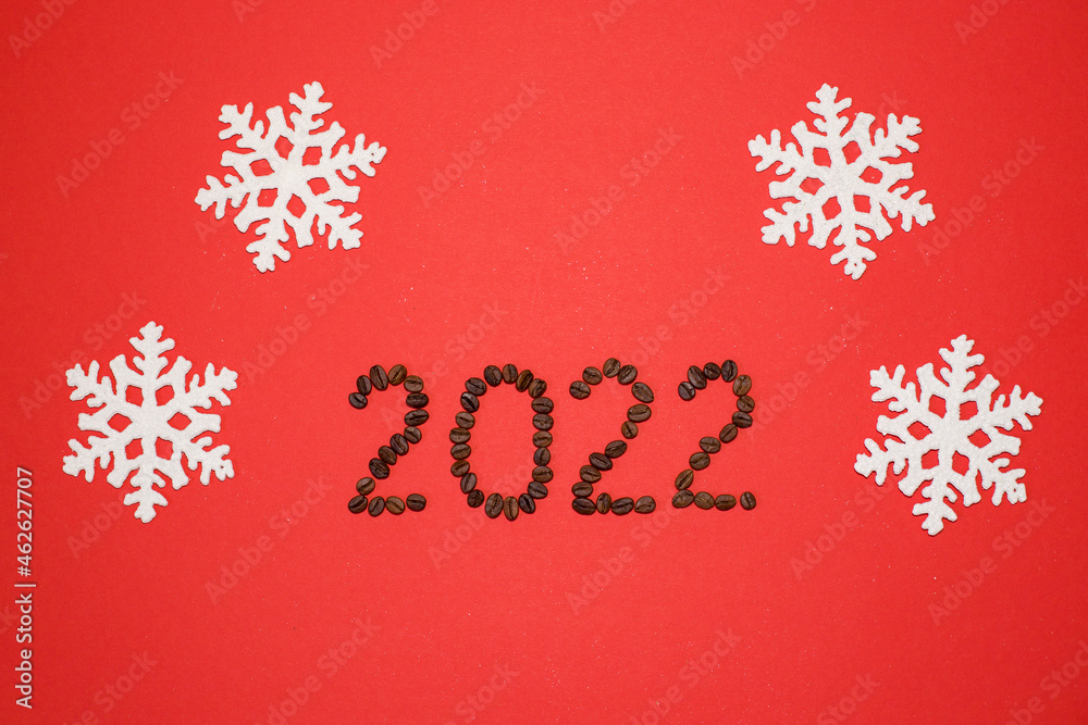 Cristmas figures 2022 with coffee on red background. Christmas number 2022. Christmas figures 2022 with snowflakes. Christmas background.