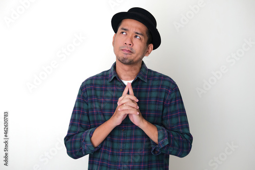 Adult Asian man showing doubtful gesture photo