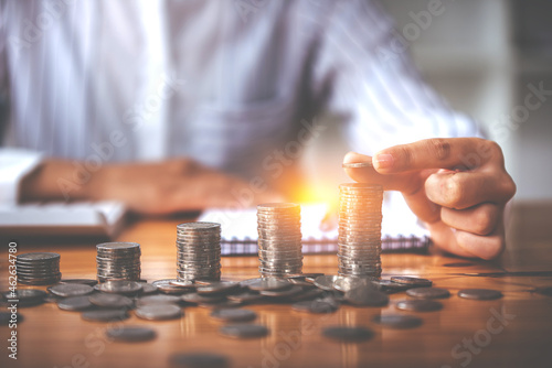 Holding the money saving coin, place the coin on the sunlit table. Finance and Accounting Concepts