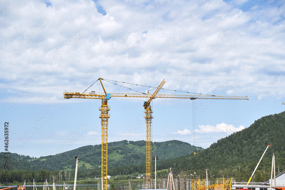 Demolition constuction. Crane machine build skyscaper at mountain. Earthwork truck operator. Manzherok view. House development. Tower equipment Demolition constuction. Crane machine build skyscaper at mountain. Earthwork truck operator. Manzherok view. House development. Tower equipment