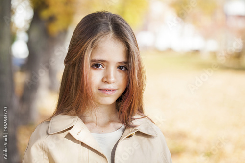 Happy little girl in an autumn park