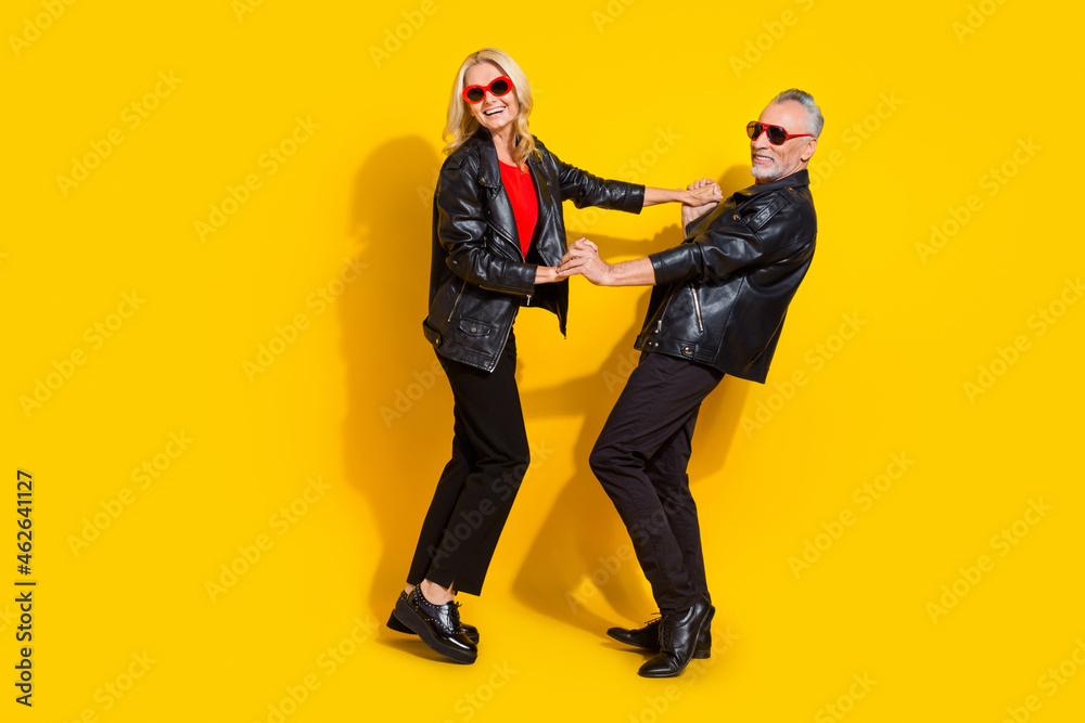 Full length body size view of beautiful handsome pensioner lovers dancing rest night club isolated over vivid yellow color background Full length body size view of beautiful handsome pensioner lovers dancing rest night club isolated over vivid yellow color background