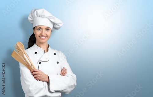 cheerful lady holding kitchen wares, food concept