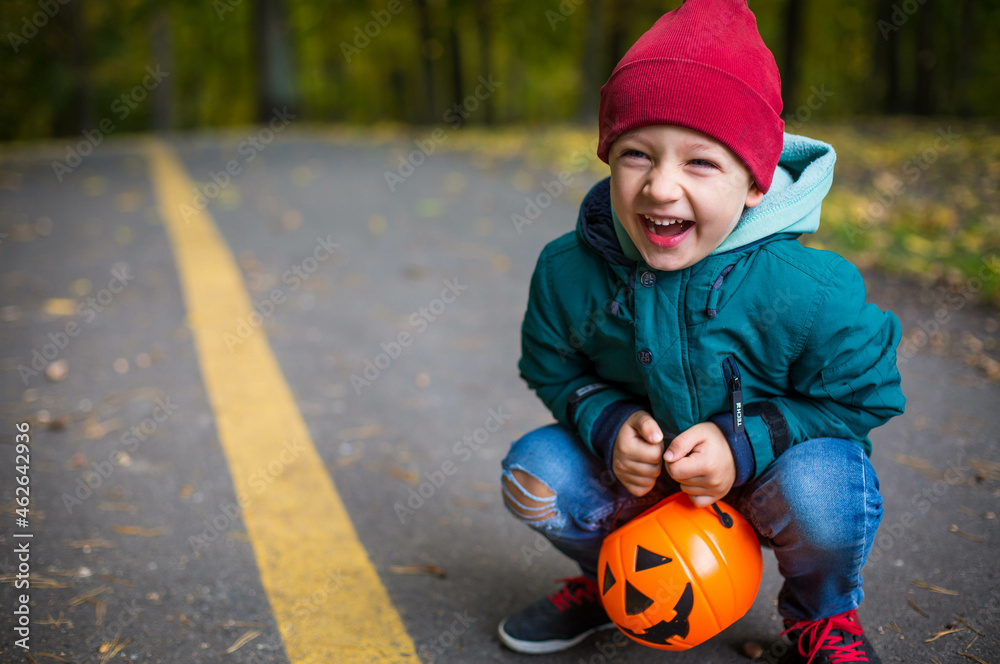 boy in autumn park with halloween pumpkin. boy in autumn park with halloween pumpkin.