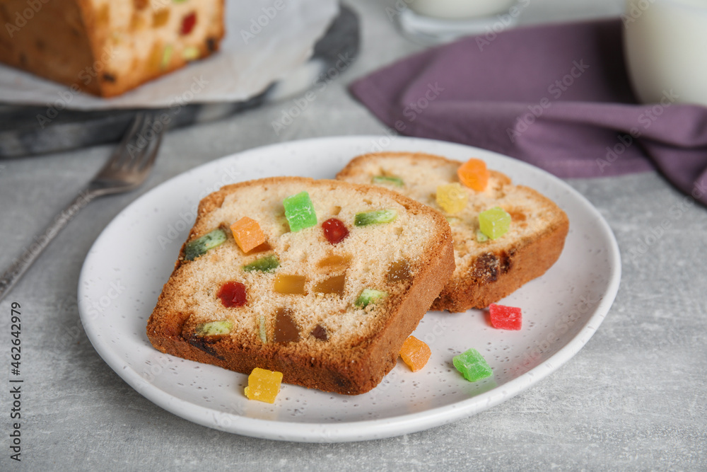Delicious cake with candied fruits on light grey table Delicious cake with candied fruits on light grey table