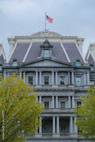 Oppulent impressive building architecture facades with columns, domes and statues of government houses in Washington D.C., DC with American flag Stars and Stripes banner photo