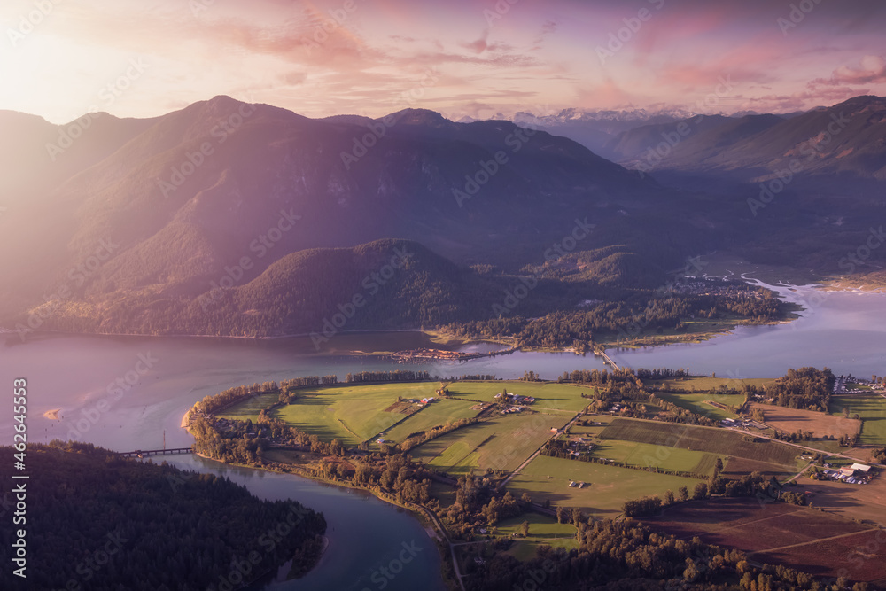 Fototapeta premium Aerial View of Fraser Valley with Canadian Nature Mountain Landscape Background. Colorful Sunset Sky Art Render. Harrison Mills near Chilliwack, British Columbia, Canada.